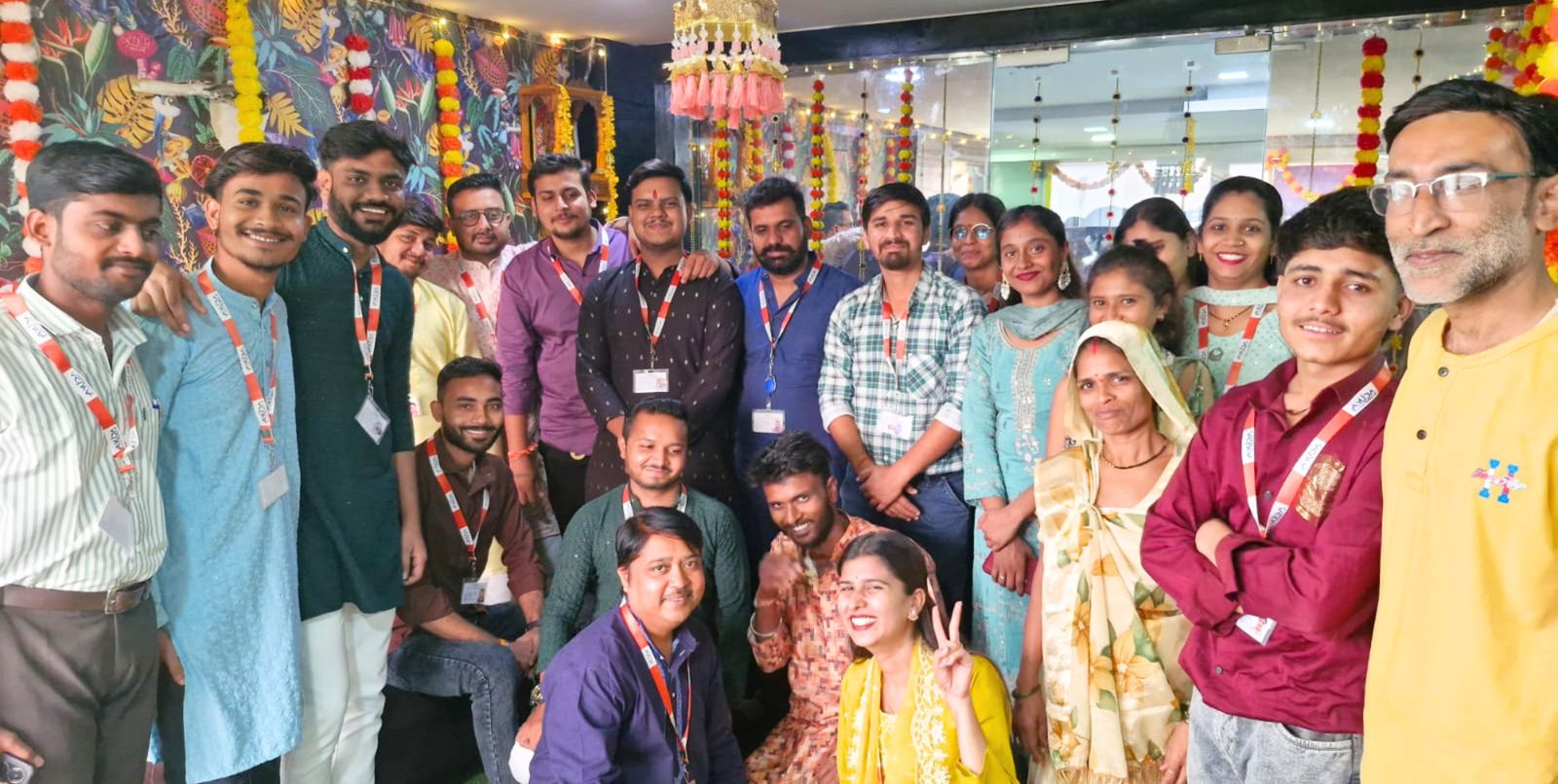 Ayuda team celebrating Diwali together under marigold garlands and festive lights